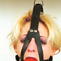 Hung upside down with clothespins on her pussy lips.