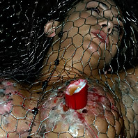 Trina Michaels gets stapled to the floor for hot wax fun.