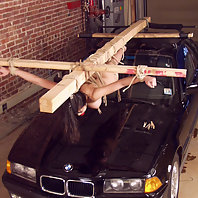 Mika crucified on the hood of a car.