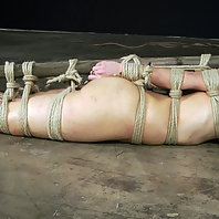 Elise is suspended from her stomach in a hogtie and she has a feeling that things are about to get f