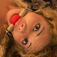Kiki bound and gagged, helpless on the floor.