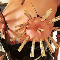Suspension bondage with tit torture.