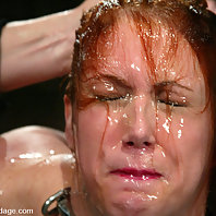Statuesque redhead is bound and water tortured