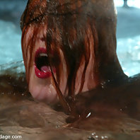 Statuesque redhead is bound and water tortured